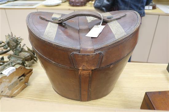 A Harrods black silk top hat, original fitted leather case, a Dunn & Co grey silk top hat and a fox fur stole